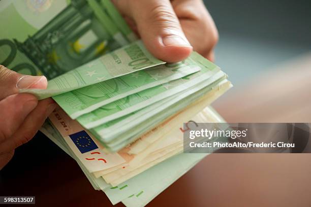 hands countong stack of money, cropped - euro in hand bildbanksfoton och bilder