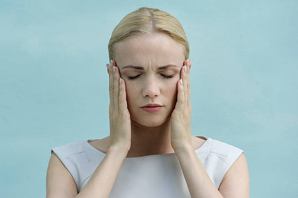 woman holding face in hands, eyes closed - hold your head up stock pictures, royalty-free photos & images