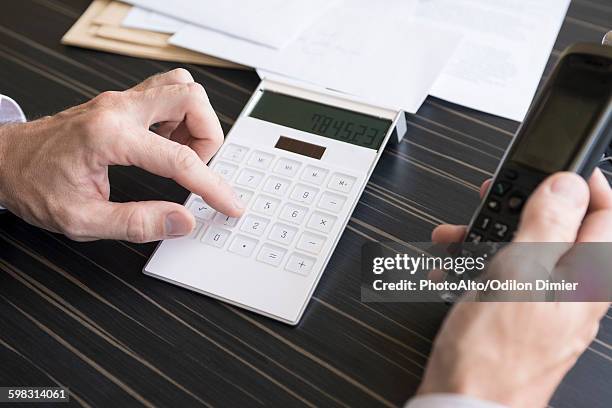 using calculator and cell phone - whistleblower stock pictures, royalty-free photos & images