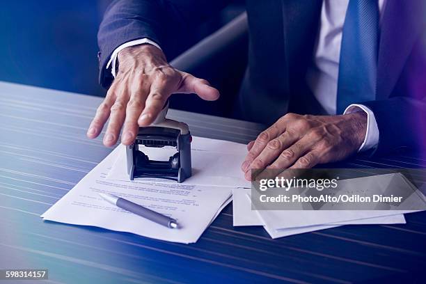 businessman stamping document - notary stock pictures, royalty-free photos & images