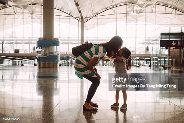little daughter kissing goodbye at the airport - asian mom kid kiss bildbanksfoton och bilder