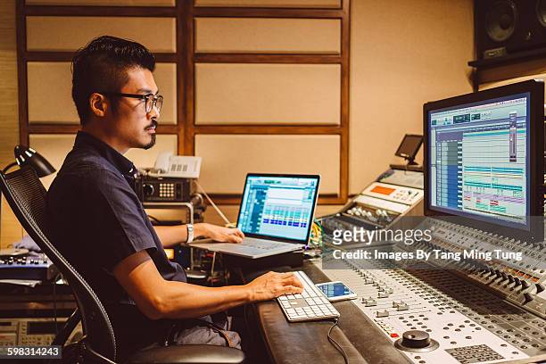 audio engineer working in recording studio - recording studio stock-fotos und bilder