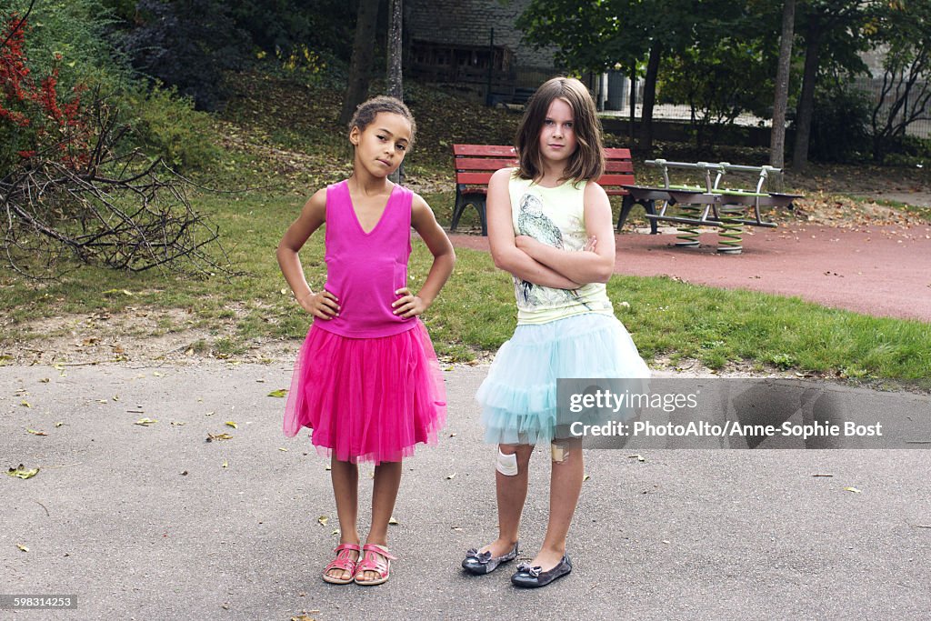 Girls dressed in tutus with tough expression on faces