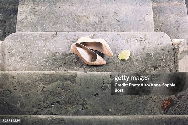 high heel dress shoes left on stairs - cinderella ストックフォトと画像