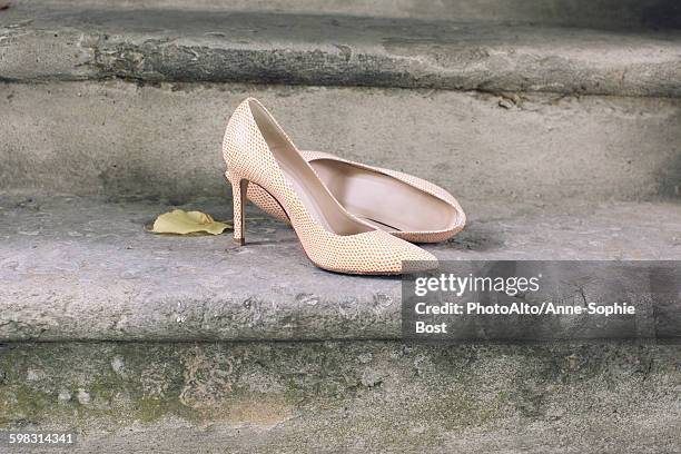 high heel dress shoes left on stairs - cinderella ストックフォトと画像