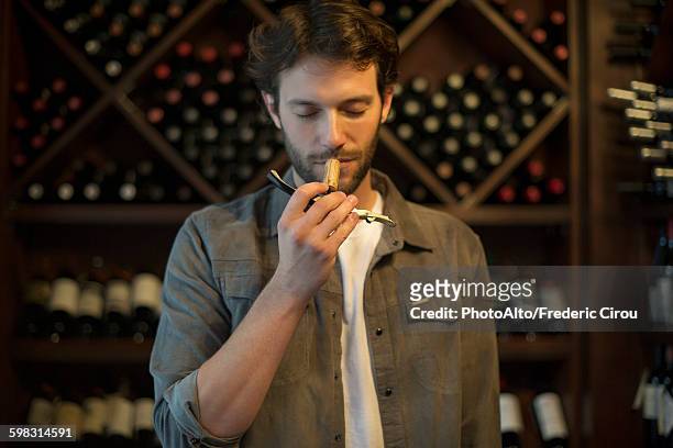 sommelier smelling wine cork - ワイン醸造業者 ストックフォトと画像