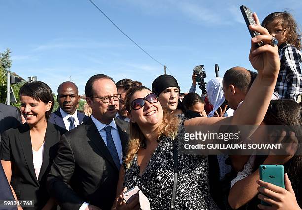 French President Francois Hollande , flanked by French Minister of Education Najat Vallaud-Belkacem , poses for a picture after his visit at the...