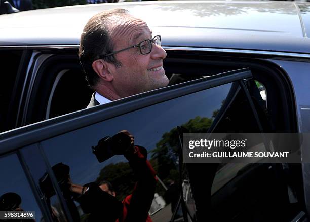 French President Francois Hollande smiles as he leaves the secondary school Jean Rostand after his visit for the first day of the starting of the...