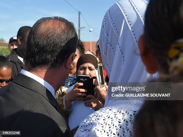 French President Francois Hollande poses for photographs as he leaves the secondary school Jean Rostand after his visit for the first day of the...
