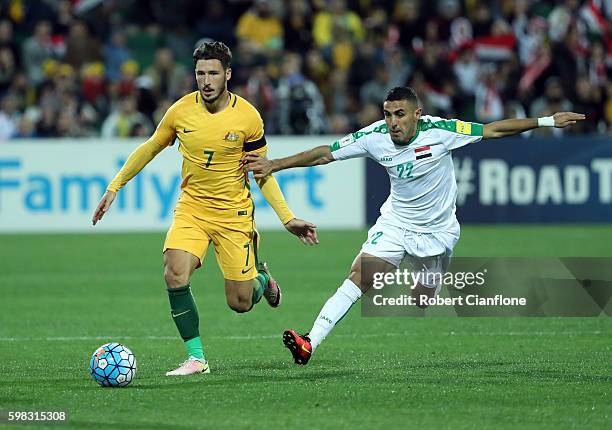 Mathew Leckie of Australia is chased by Ali Abbas of Iraq during the 2018 FIFA World Cup Qualifier match between the Australian Socceroos and Iraq at...