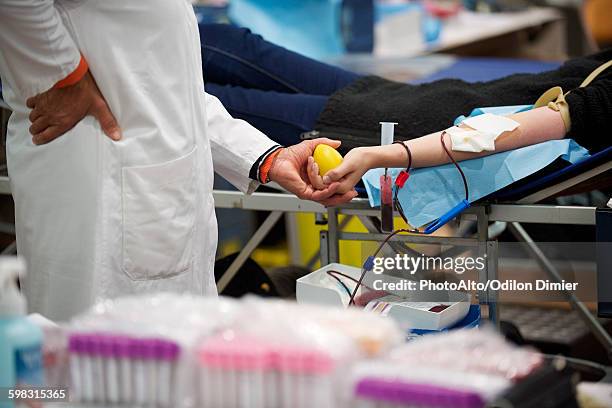 person donating blood, cropped - banco de sangre fotografías e imágenes de stock