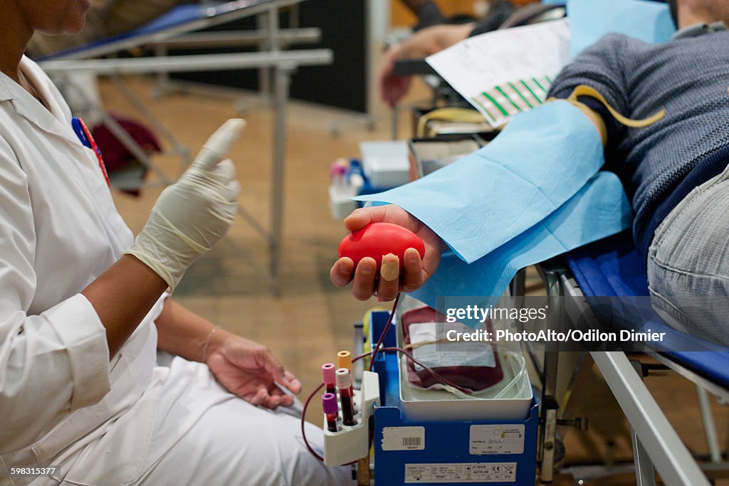 Person donating blood, cropped