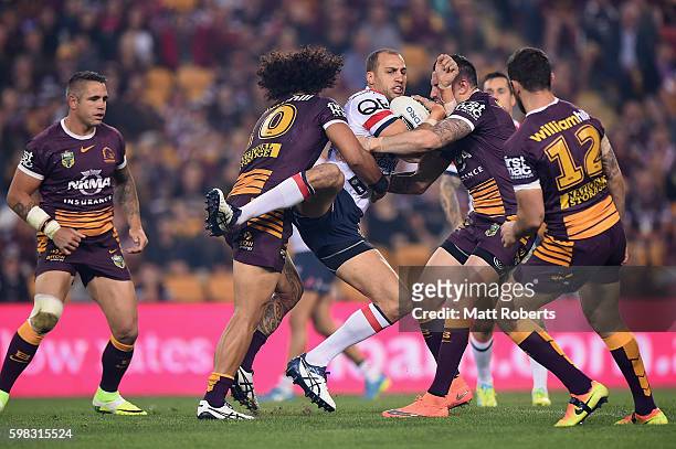 Blake Ferguson of the Roosters is tackled during the round 26 NRL match between the Brisbane Broncos and the Sydney Roosters at Suncorp Stadium on...