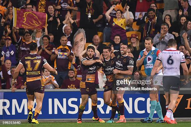 James Roberts of the Broncos celebrates scoring a try with team mates during the round 26 NRL match between the Brisbane Broncos and the Sydney...