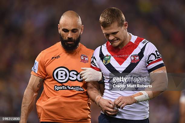 Dale Copley of the Roosters leaves the field injured during the round 26 NRL match between the Brisbane Broncos and the Sydney Roosters at Suncorp...