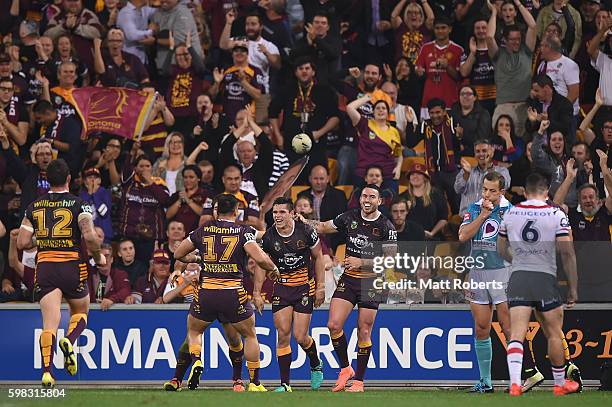 James Roberts of the Broncos celebrates scoring a try with team mates during the round 26 NRL match between the Brisbane Broncos and the Sydney...
