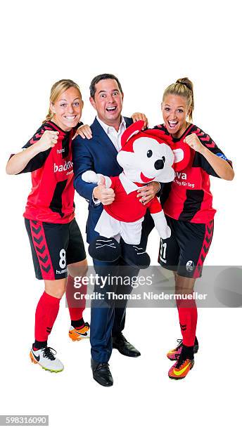 Juliane Maier and Selina Wagner of SC Freiburg pose with Michael Sehringer of Allianz during the Allianz Women's Bundesliga Club Tour on August 31,...