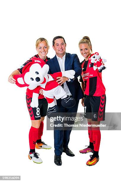 Juliane Maier and Selina Wagner of SC Freiburg pose with Michael Sehringer of Allianz during the Allianz Women's Bundesliga Club Tour on August 31,...