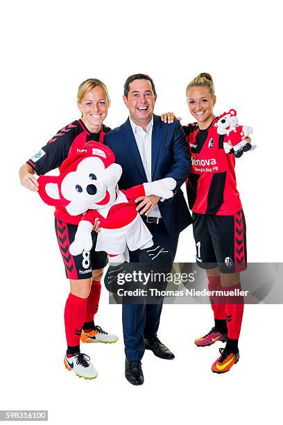 Juliane Maier and Selina Wagner of SC Freiburg pose with Michael Sehringer of Allianz during the Allianz Women's Bundesliga Club Tour on August 31,...