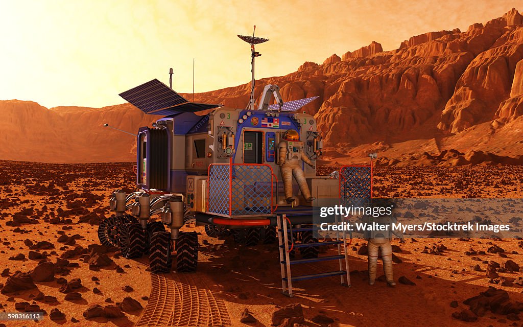 An explorer departs a manned rover ina martian canyon.