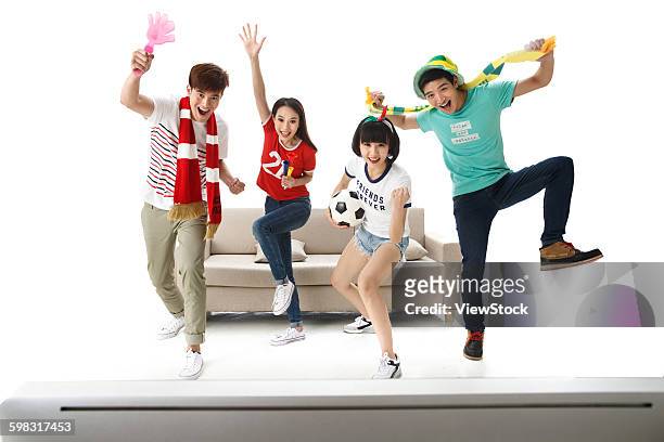 young men and women watching football matches - china fans cheer stock pictures, royalty-free photos & images