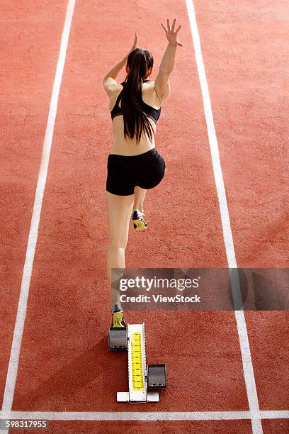 female track and field athlete running - indoor track and field stock pictures, royalty-free photos & images