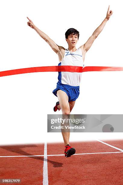 track and field athletes to reach the finish line - indoor track and field stock pictures, royalty-free photos & images