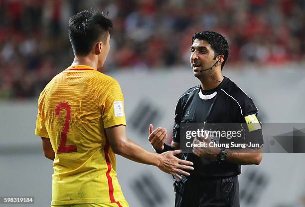 Referee Mohammed Abdulla Hassan talks to Ren Hang of China during the 2018 FIFA World Cup Qualifier Final Round Group A match between South Korea and...