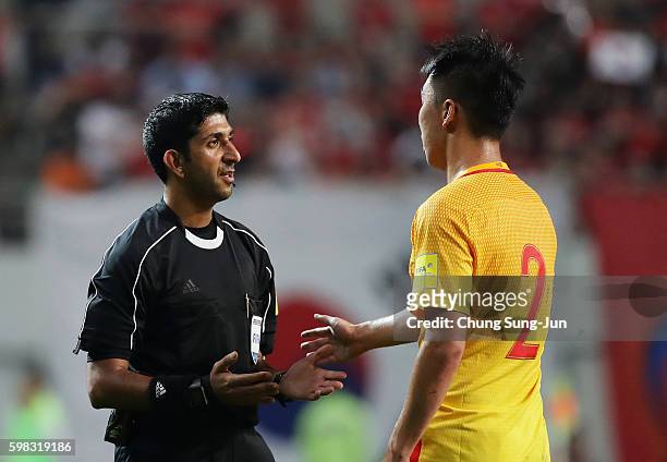 Referee Mohammed Abdulla Hassan talks to Ren Hang of China during the 2018 FIFA World Cup Qualifier Final Round Group A match between South Korea and...