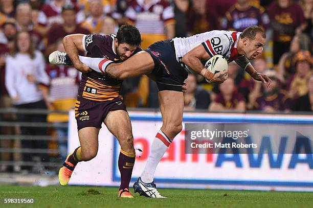 Blake Ferguson of the Roosters is tackled by Ben Hunt of the Broncos during the round 26 NRL match between the Brisbane Broncos and the Sydney...