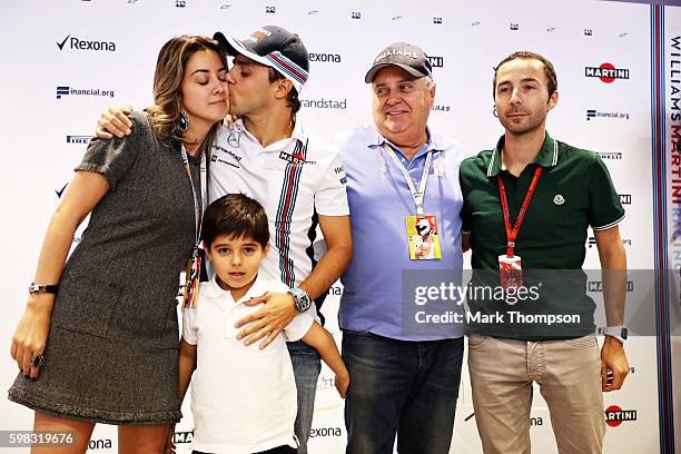 Felipe Massa of Brazil and Williams kisses his wife Anna Raffaela Bassi, and stands with his son, Felipinho Massa, father, Luís Antonio Massa and...