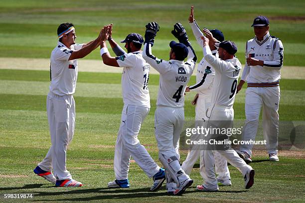 Jack Brooks of Yorkshire celebrates with team mates after taking the wicket of Hampshire's Will Smith during day two of the Specsavers County...