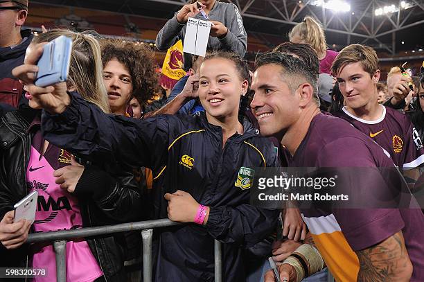 Corey Parker of the Broncos takes a photo with fans after the round 26 NRL match between the Brisbane Broncos and the Sydney Roosters at Suncorp...