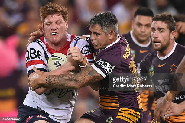 Dylan Napa of the Roosters is tackled by Corey Parker of the Broncos during the round 26 NRL match between the Brisbane Broncos and the Sydney...