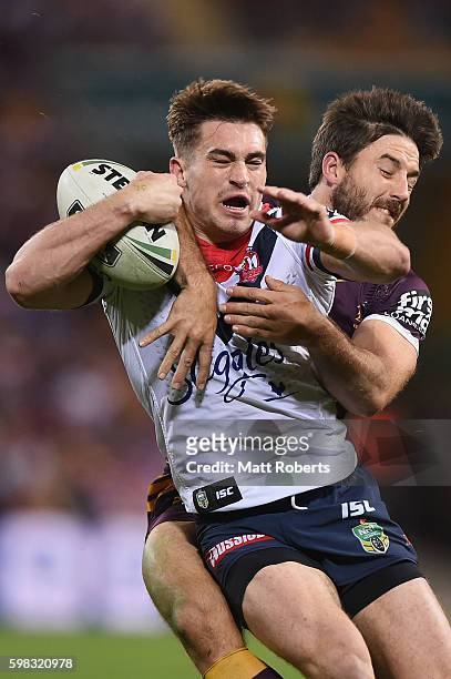 Connor Watson of the Roosters is tackled by Ben Hunt of the Broncos during the round 26 NRL match between the Brisbane Broncos and the Sydney...