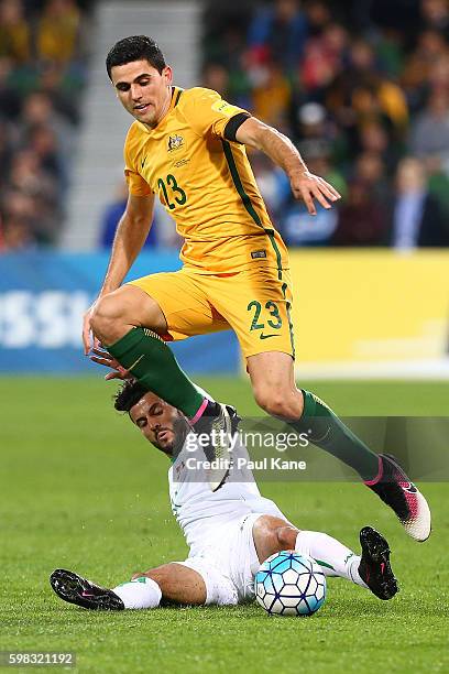 Amjed Waleed Hussein of Iraq challenges Tommy Rogic of Australia during the 2018 FIFA World Cup Qualifier match between the Australian Socceroos and...