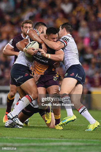 Alex Glenn of the Broncos is tackled during the round 26 NRL match between the Brisbane Broncos and the Sydney Roosters at Suncorp Stadium on...