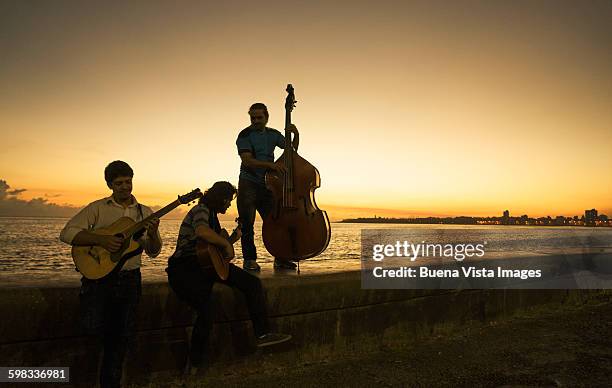 music group on el malecon at sunrise - playing music together stock-fotos und bilder