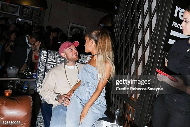 Ariana Grande sitting on Mac Miller's lap at the Republic Records 2016 VMA afterparty at Vandal in New York, NY on August 28, 2016.