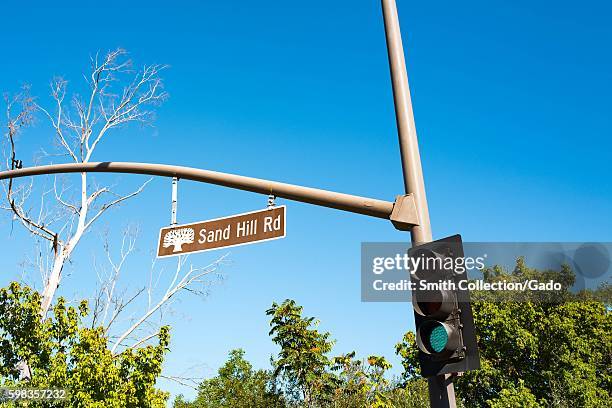 Iconic sign for Sand Hill Road, with a green traffic light signaling "Go", on Sand Hill Road in the Silicon Valley town of Menlo Park, California,...