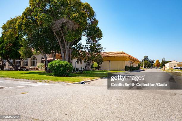 Spanish Colonial Revival style buildings with large trees within the secure area of the NASA Ames Research Center campus in the Silicon Valley town...