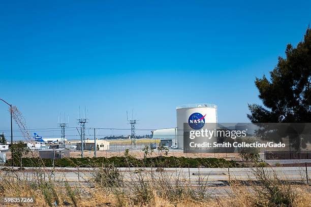 Storage tank with logo for NASA Ames Research Center, with Moffett Field visible in the background, in the Silicon Valley town of Mountain View,...