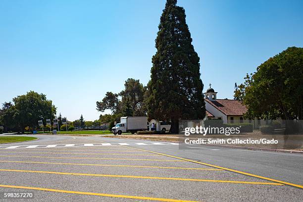 Road passes by a Spanish Colonial Revival style building on a sunny day within the secure area of the NASA Ames Research Center campus in the Silicon...