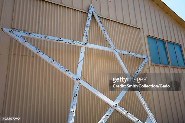 Iconic five-point lighted star from Hanger One rests against the site of the Moffett Field Historical Museum within the secure area of the NASA Ames...