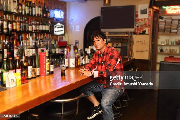 japanese man sitting in bar - atsushi yamada stock pictures, royalty-free photos & images