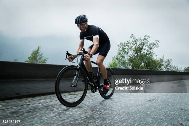 male race cyclist on mountain road - road cycling stock pictures, royalty-free photos & images