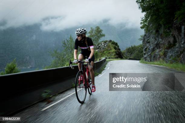 female cyclist on mountain road - norway womens training session stock pictures, royalty-free photos & images