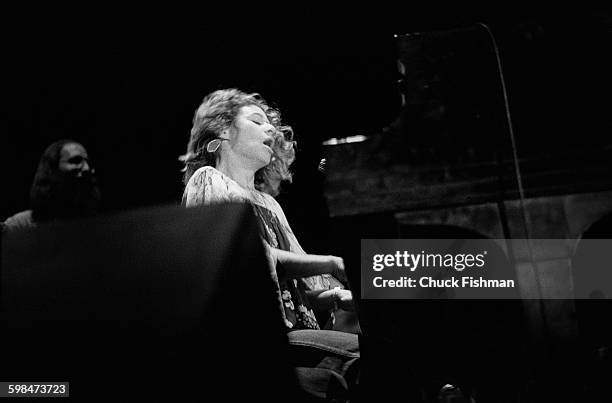 American composer and musician Carole King plays piano as she performs onstage at Southern Illinois University, Carbondale, Illinois, 1976.