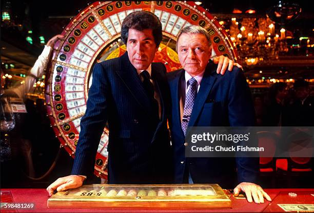 American businessman Steve Wynn and entertainer Frank Sinatra pose in front of a Big Six wheel in Wynn's Golden Nugget Casino, Atlantic City, New...