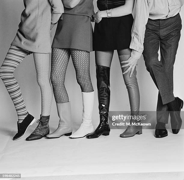 Footwear fashion shoot, UK, 29th September 1967. From left to right, a damson suede 'Charlie' style boot by Lennards with striped stocking by Echo; a...